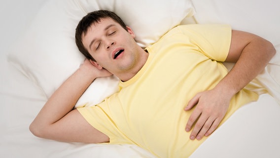 Mann schläft mit offenem Mund in einem Bett © Colourbox Foto: Pressmaster