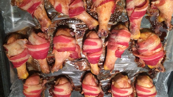 Gegrillte Hähnchenschenkel mit Speck umwickelt Gegrillte Hähnchenschenkel mit Speck umwickelt