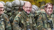 Die Köpfe von Peter Tauber, Martin Schulz und Ralf Stegner sind auf die Körper von Soldaten montiert.  