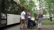 Familie Taramosuh-Kalash steht neben einem Bus.  