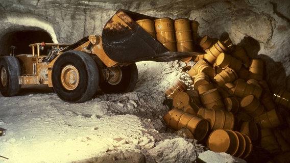 Ein Radlader kippt in der Schachtanlage Asse Fässer mit radioaktivem Müll in eine Kammer.  