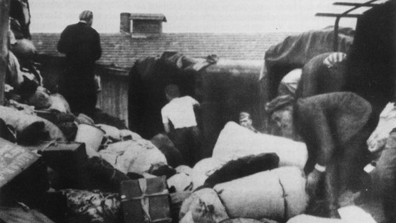 Gegenstände aus dem Besitz neu in Auschwitz eingetroffener Häftlinge werden nach Dingen durchsucht, die der SS im Lager zur Verfügung gestellt werden. ©  picture alliance / Mary Evans Picture Library 