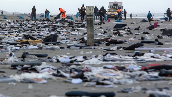 Freiwillige sammeln am Strand der niederländischen Insel Ameland angespülte Waren ein, die aus den über Bord gegangenen Containern der "MSC Zoe" stammen. © picture alliance/Jan Spoelstra/dpa Foto: Jan Spoelstra