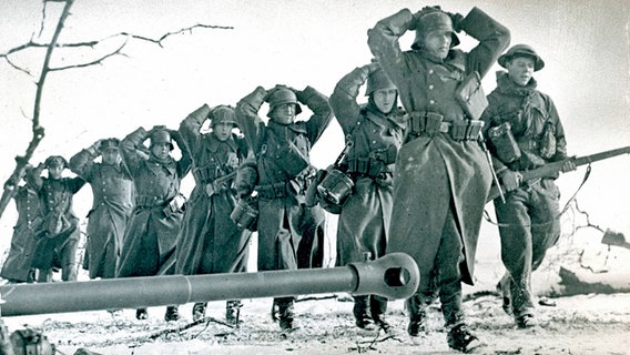 Ein britischer Soldat bewacht eine Gruppe deutscher Kriegsgefangener. - Foto wohl 1945, ohne Ort © picture alliance / akg-images 