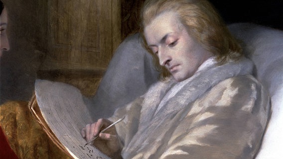 Wolfgang Amadeus Mozart schreibt eine Komposition nieder. Detail-Ausschnitt eines Ölbildes. © picture alliance / Heritage-Images | Mithra - Index / Heritage-Images 