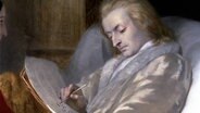 Wolfgang Amadeus Mozart schreibt eine Komposition nieder. Detail-Ausschnitt eines Ölbildes. © picture alliance / Heritage-Images | Mithra - Index / Heritage-Images 