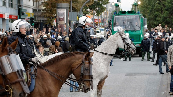 Die Reiterstaffel der Hamburger Polizei sichert am 19.09.2010 den Weg der HSV-Fans zum Millerntor Stadion. © dpa-Bildfunk Foto: Markus Scholz