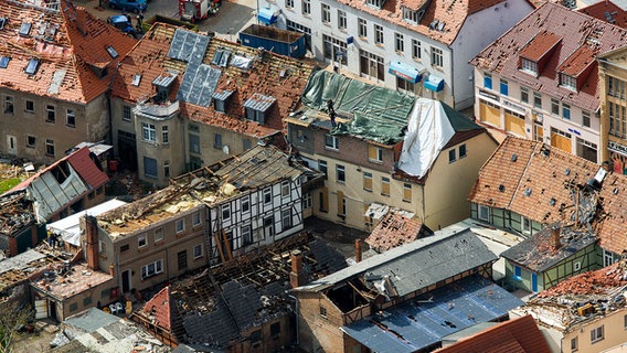 Nach dem schweren Tornado räumen Anwohner, Helfer und Feuerwehrleute Dachbalken und Ziegelsteine von zerstörten Häusern in der Altstadt. Der Tornado, der am Abend des 05.05.2015 durch Bützow fegte, hatte einen Schaden von rund 40 Millionen Euro angerichtet. © picture alliance/dpa/dpa-Zentralbild Foto: Jens Büttner