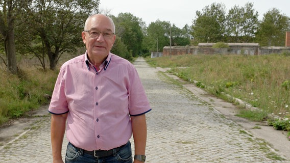 Hartmut Polzin steht auf der Zufahrt zur Halbinsel Wustrow. © NDR Foto: Daniel Sprenger