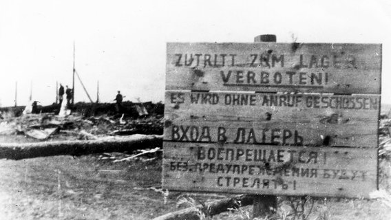 Die Aufnahme von 1944 zeigt ein Schild von Malyj Trostenez mit der Aufschrift "Zutritt zum Lager verboten. Es wird ohne Anruf geschossen"  