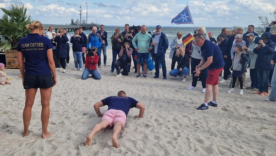 Ein Mann macht Liegestütze am Strand © NDR Foto: Jannik Wölffel
