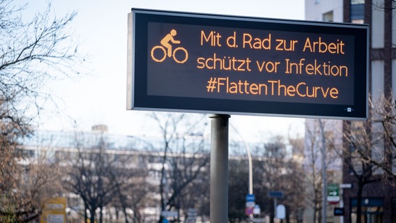 Eine LED-Anzeige in Berlin mit der Nachricht: Mit dem Rad zur Arbeit schützt vor Infektion #flattenthecurve © picture-alliance Foto: Kay Nietfeld/ dpa