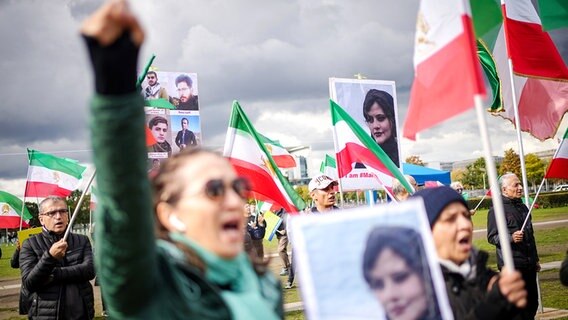 Mit Plakaten von Masha Amini demonstrieren Teilnehmer für Demokratie und Freiheit im Iran auf der Reichstagswiese in Berlin. © dpa Foto: Kay Nietfeld