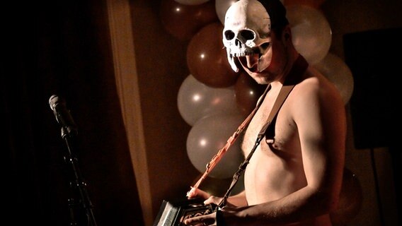 Maximilian Scheidt mit Gitarre und Totenkopf in "Aus dem Leben" - Inszenierung von Karin Beier im Malersaal am Deutschen Schauspielhaus Hamburg © Thomas Aurin 2021 Foto: Thomas Aurin