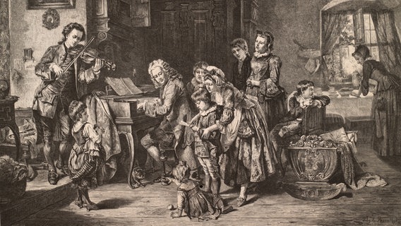 Die Familie des Komponisten Johann Sebastian Bach auf einem Holzstich von 1870. Der Komponist sitzt im Zentrum an einem Klavier, um ihn herum ist seine Familie gruppiert. © picture-alliance / akg-images Foto: akg-images