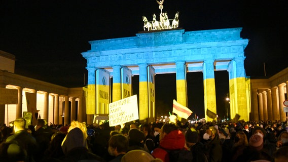Blick auf das Brandenburger Tor, das in den Farben der Ukrainischen Flagge angestrahlt ist. © IMAGO / Future Image 