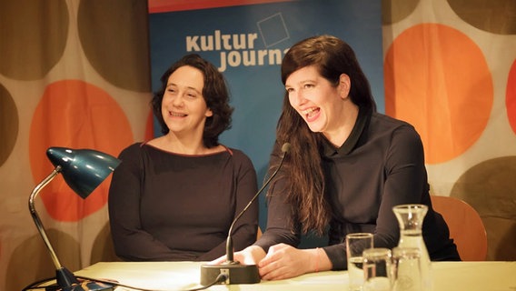 Lucy Fricke (l.) und Karen Köhler lachend hinter einem Lesepult. © Stefan Albrecht 