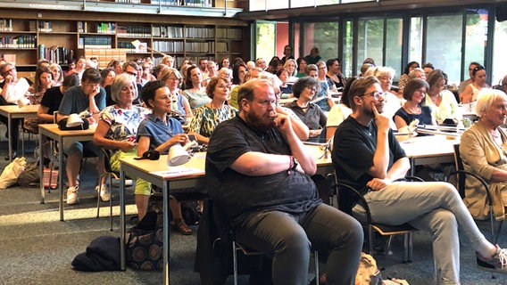Gäste hören bei der Veranstaltung mit den Hosts von eat.READ.sleep. in Trier in einer Bibliothek zu © NDR Foto: Birgit Laabs