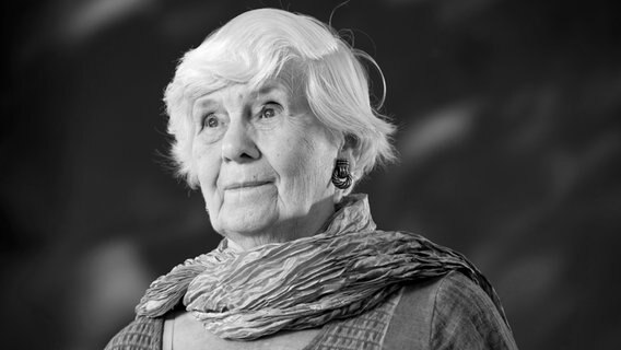 Eine ältere Dame mit Bubischopf lächelt versonnen, sie trägt ein Tuch - Die britische Autorin Jane Gardam © picture alliance / Photoshot 