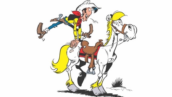 Lucky Luke springt auf sein Pferd Jolly Jumper. © Lucky Comics 2021 © Lucky Comics 2021 