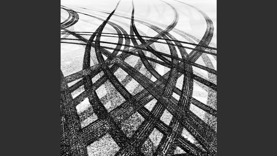 Foto aus dem Bildband "City Visions": Mehrere Spuren von Autoreifen im Schnee © Peter Arnell 