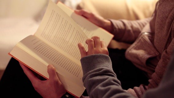 Kind blättert eine seite beim Vorlesen um © picture alliance/dpa | Hans-Thomas Frisch 
