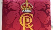 Detailansicht des königlichen Schriftzugs auf dem Thronsessel von König Charles III. © Andrew Matthews/PA Wire/dpa +++ dpa-Bildfunk +++ Foto: Andrew Matthews
