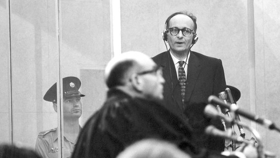 Der Angeklagte Adolf Eichmann während des Prozesses im schusssicheren Glaskasten. © dpa | DB 