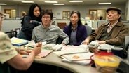 Eine Szene bei der Finanzbeamtin mit der ganzen Familie um Evelyn Wang (Michelle Yeoh, Mitte) aus "Everything Everywhere All at Once" - ein Science-Fiction-Film von Dan Kwan, Daniel Scheinert © Leonine 