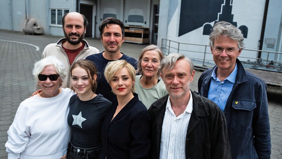 Eine Gruppe von Menschen am Filmset lächelt in die Kamera (Das Filmteam vom  İlker Çatak am Set von seinem Drama "Gelbe Briefe") ©  if… Productions Film GmbH / Ella Knorz Foto: Ella Knorz