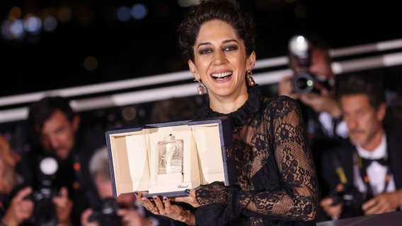 Iranian actress Zahra Amir Ebrahimi with her palm as best actress in Cannes © Vianney Le Caer / Invision / AP / dpa +++ dpa-Bildfunk Photo: Vianney Le Caer