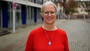 Die Autorin Isabel Bogdan steht auf der Straße und trägt einen roten Pulli. © NDR 90,3 Foto: Marco Peter