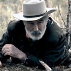 Szene aus dem Film "Rust - Legende des Westens": Ein älterer Mann und ein Junge liegen auf der Lauer. © 2025 RUST MOVIE PRODUCTIONS LLC, ALL RIGHTS RESERVED 