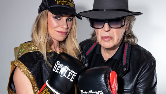 Natalie Zimmermann und Udo Lindenberg stehen dicht nebeneinander und heben jeweils eine Faust, die in einem Boxhandschuh steckt. © picture alliance/dpa/Tine Acke | Tine Acke 