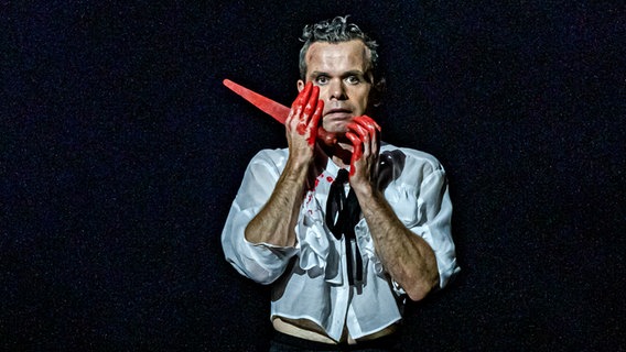 Macbeth steht blutverschmiert mit einem Messer vor einem Sternenhimmel. © Lalo Jodlbauer Foto: Lalo Jodlbauer