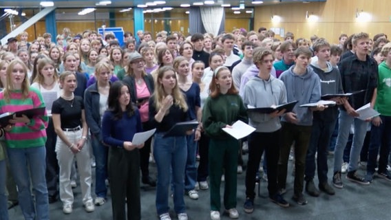 Etwa sechzig Jugendliche haben sich in einer Aula zum Singen versammelt © NDR 