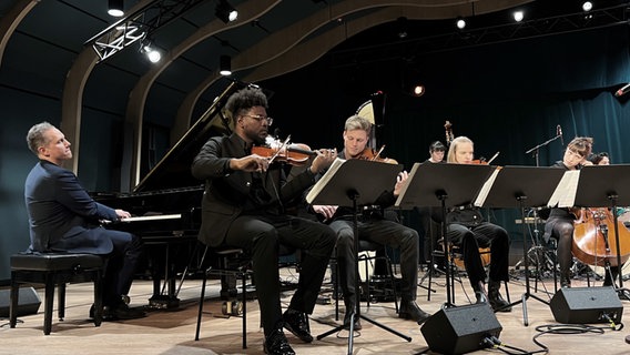 Tino Derado sitzt am Flügel und spielt mit Streichern des Large Ensemble der Hochschule für Musik und Theater Hamburg © Stefan Gerdes Foto: Stefan Gerdes