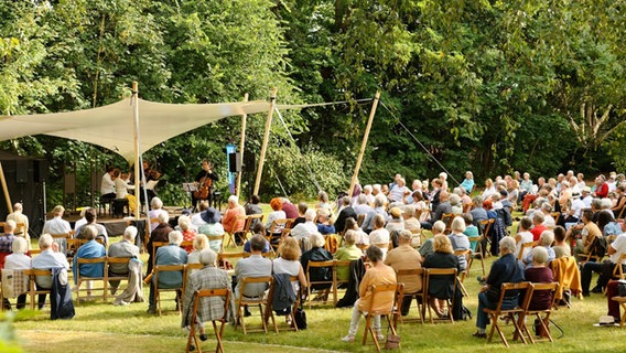 Publikum im Grünen lauschen einem Konzert © Kay-Christian Heine / Sommerliche Musiktage Hitzacker Foto: Kay-Christian Heine