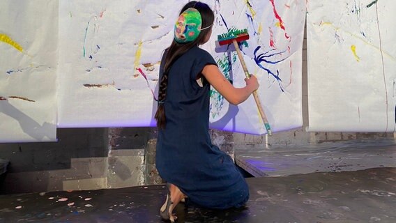 Die Malerin Misaki Ouchi malt beim Projekt SoundColours mit einem Besen. © Linda Ebener / NDR Foto: Linda Ebener