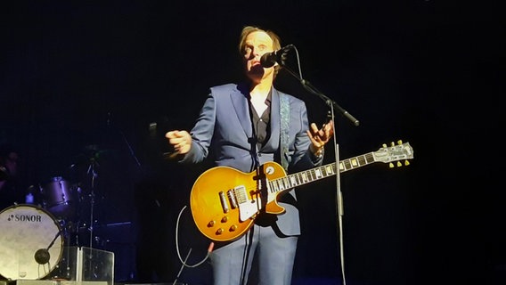 Ein Mann mit einer Gitarre vor einem Mikrofon auf einer Bühne. Es ist Joe Bonamassa. © NDR Foto: Uli Kniep