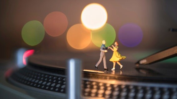 Ein Miniatur-Paar tanzt auf einer Schalplatte. © complize / photocase.de Foto: complize