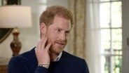 Prinz Harry hält sich eine Hand an die Wange in einem Fernsehinterview im Januar 2023 mit ITV unter dem Titel "Harry: Das Interview" © Harry: The Interview On Itv1 And/PA Media/dpa 