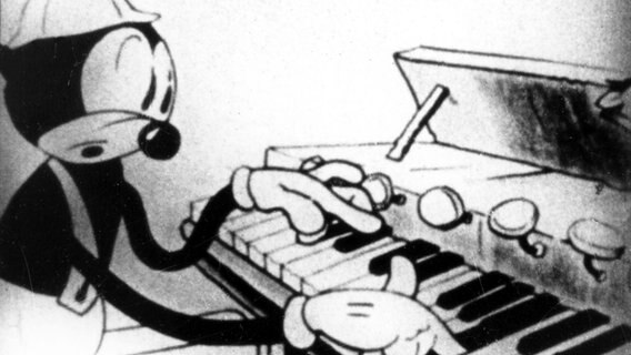 Eine schwarz-weiße Disney-Cartoon-Figur spielt ein Piano © picture-alliance / Mary Evans Picture Library 