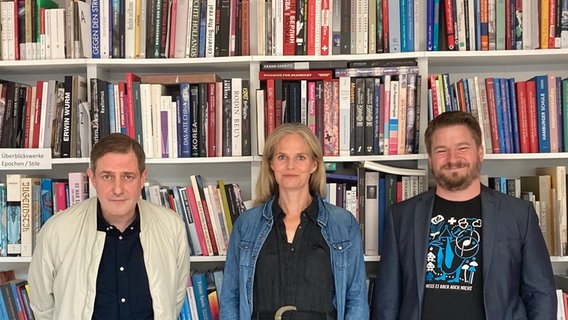 Andreas Dorau, Dota Kehr und Alexander Solloch stehen vor einer Bücherwand. © ZEIT-Stiftung Foto: Meike Egge
