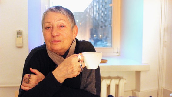 Ljudmila Ulitzkaja sitzt mit einer Tasse in der Hand an einem Tisch. © Claudia Thaler/dpa Foto: Claudia Thaler