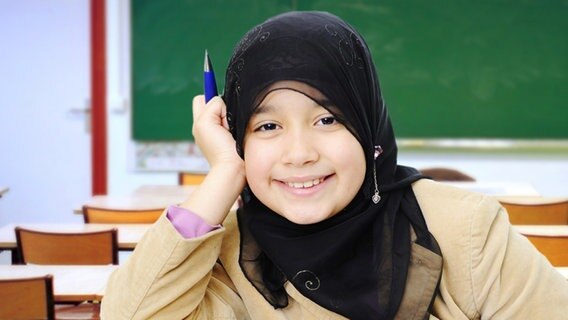 Ein islamisches Mädchen mit Kopftuch in einem Klassenraum. © iStock, Fotolia Foto: Zurijeta, Uolir