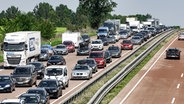 Autos stauen sich auf der Autobahn A1, auf der Fahrstreifen gesperrt sind. © picture Alliance / dpa Foto: Markus Scholz
