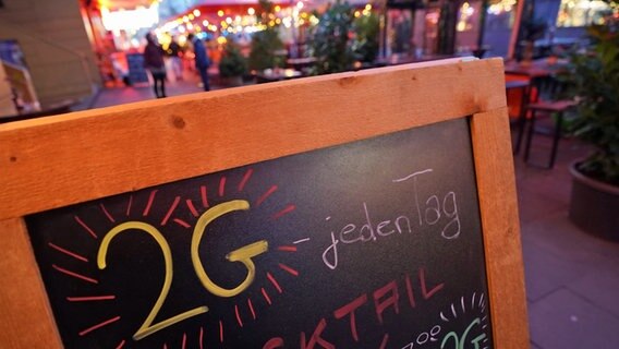 "2G - jeden Tag" steht auf einer Tafel vor einer Bar in Hamburg. © picture alliance / dpa Foto: Marcus Brandt