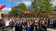 Mehrere Hundert Menschen stehen vor einer Bühne im Hamburger Schanzenviertel © NDR Foto: Finn Kessler