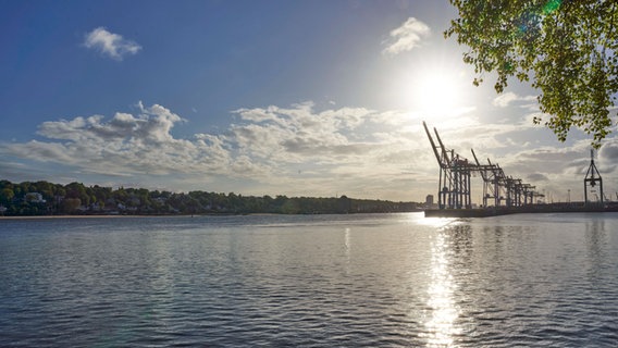 Die Elbe bei Hamburg mit Kränen und Sonne. © IMAGO / Future Image Foto: Future Image